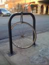 Lone locked bike wheel. (click to zoom)