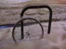 Lonely locked bike wheel in snow. (click to zoom)