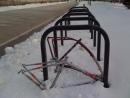 Lonely locked bike frames in snow. (click to zoom)